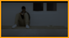 teen boy sitting in an isolation cell