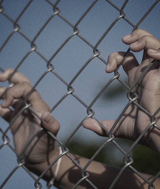 Human Rights for Kids Child hands holding chain link fence